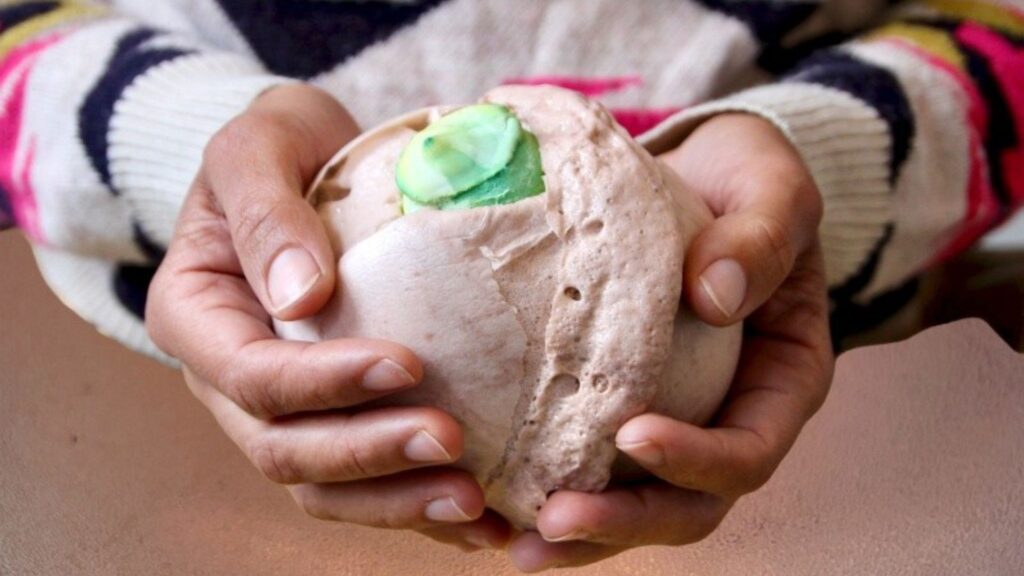 Hands touching an unknown object.